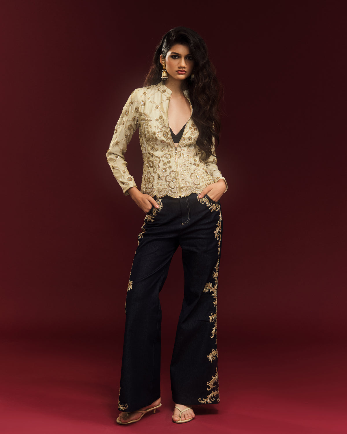 Dark indigo bell-bottom jeans featuring intricate gold dabka embroidery, zari threads and hand-sewn sequins by Alpha & Omega.
