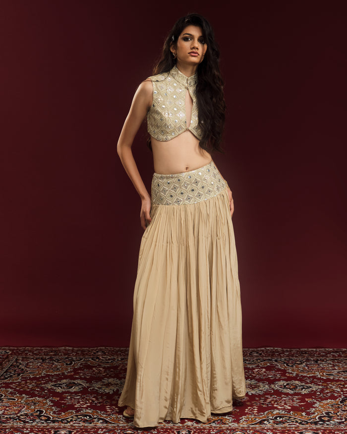Champagne mirror-work blouse paired with a flowing silk-blend crepe maxi skirt.
