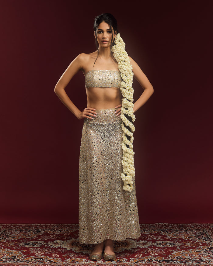 Champagne mirror-embellished bandeau blouse with a matching sheer maxi skirt by Alpha & Omega.
