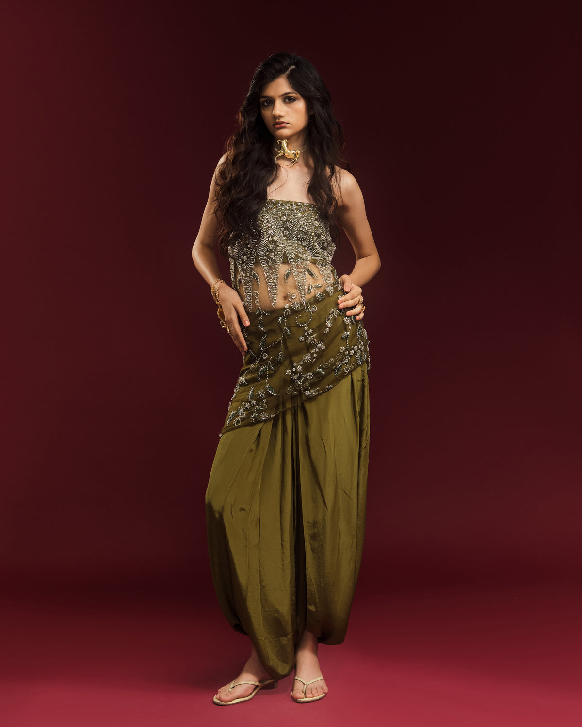 Model wearing mehendi green draped dhoti trousers with the embellished Rati Top.
